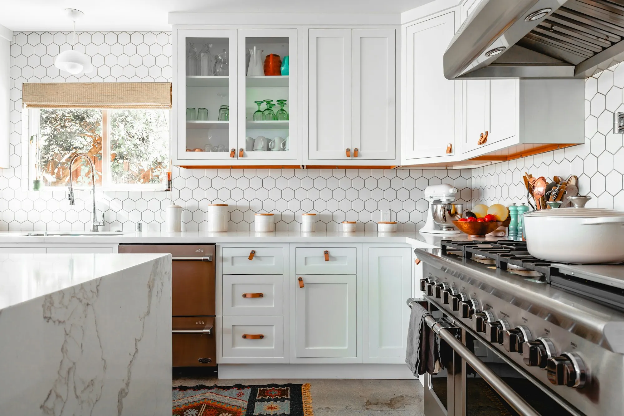 Remodeled kitchen with white cabinetry and a large island